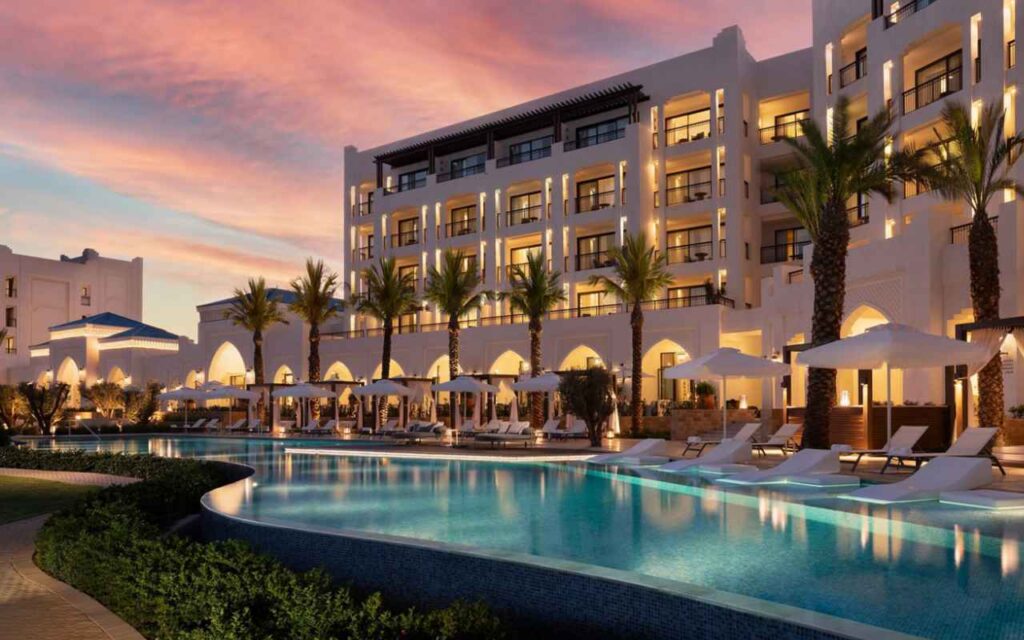 The outside of St Regis hotel, including a swimming pool and loungers, in Morocco.