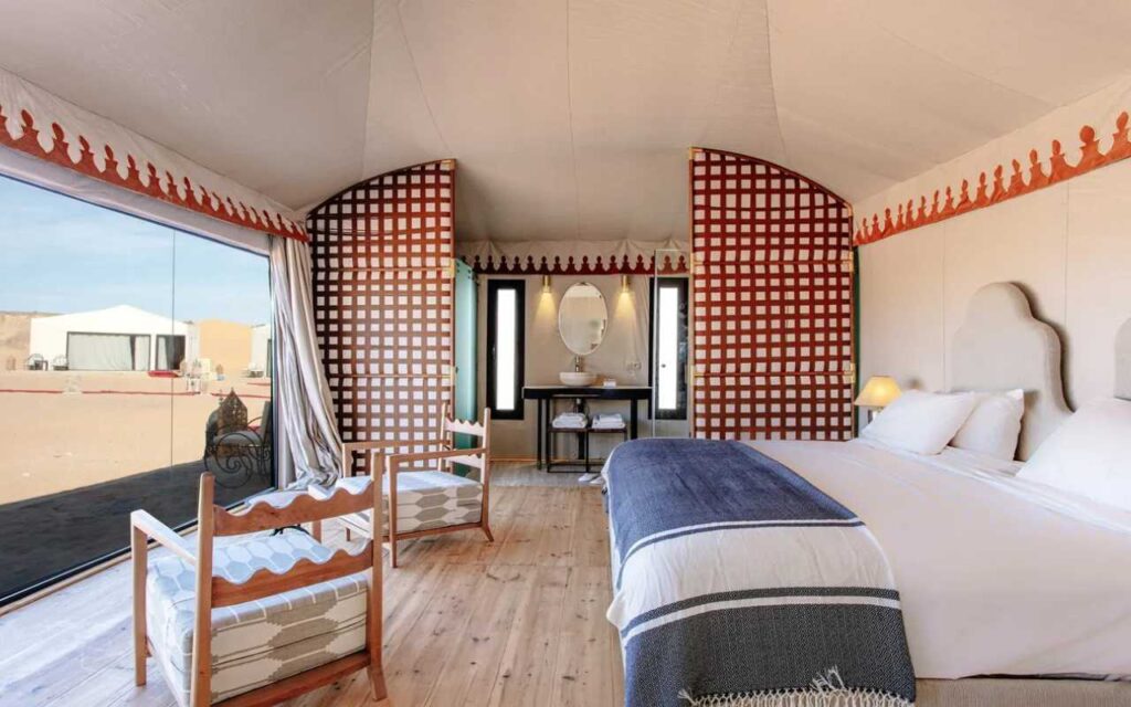 A double bedroom with seating on safari in Morocco.