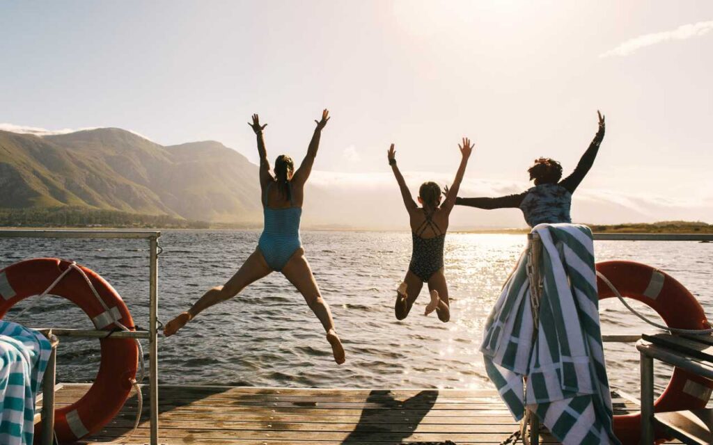 a family jumping into a lagoon