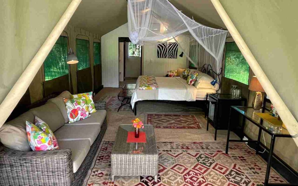 Accommodation with a double bed and seating on a family safari in Zambia.