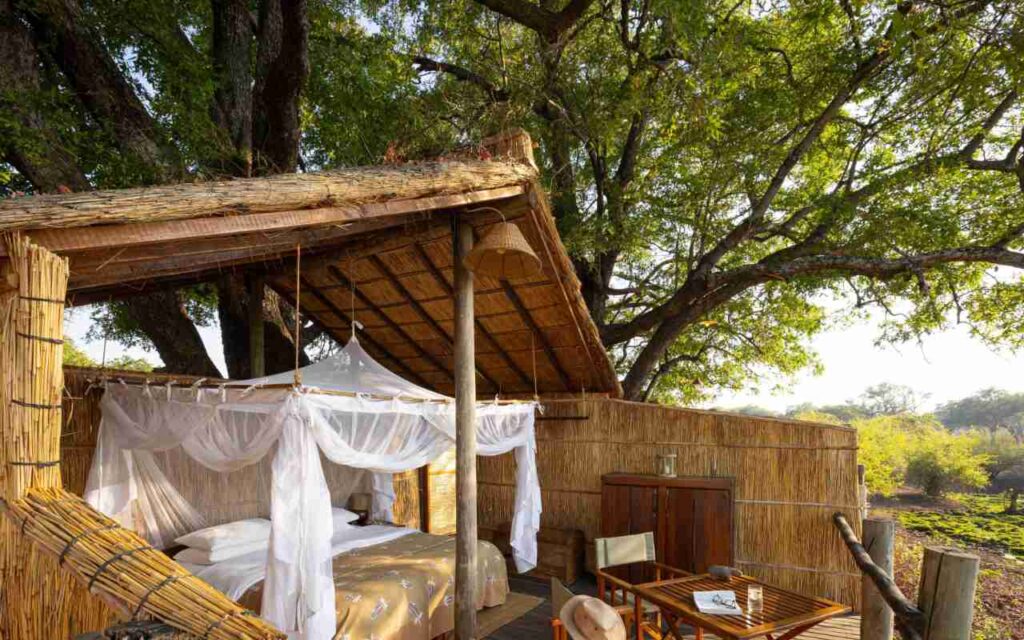 Safari lodge accommodation with a double bed and seating.